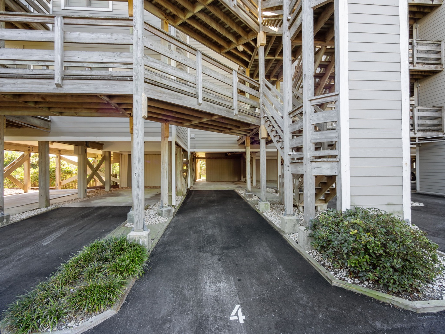 Your covered parking spot awaits beneath charming wooden balconies and railings.
