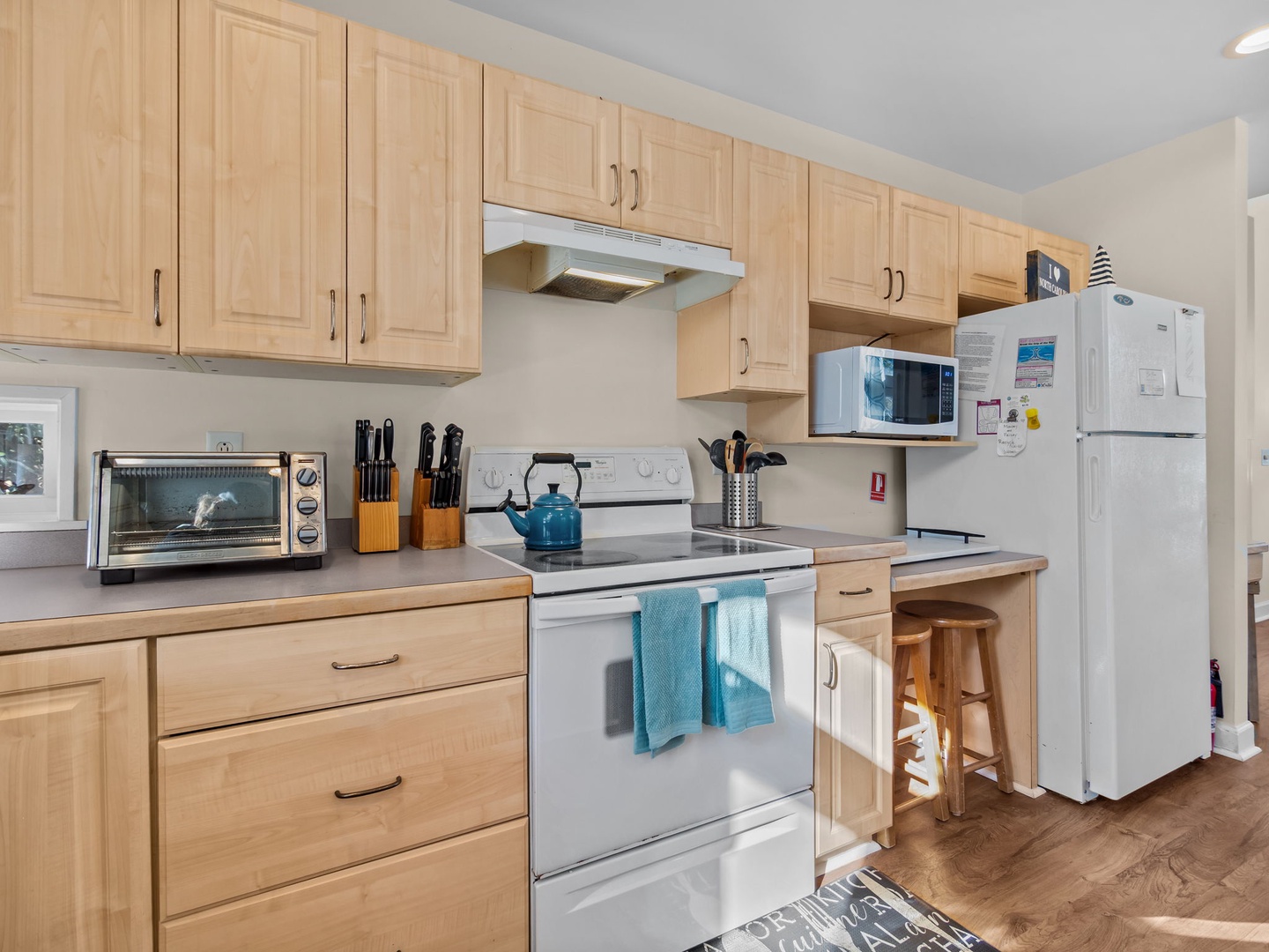 Whip up delicious meals in your fully equipped kitchen with modern appliances, warm wood cabinetry, and everything you need for a perfect stay.