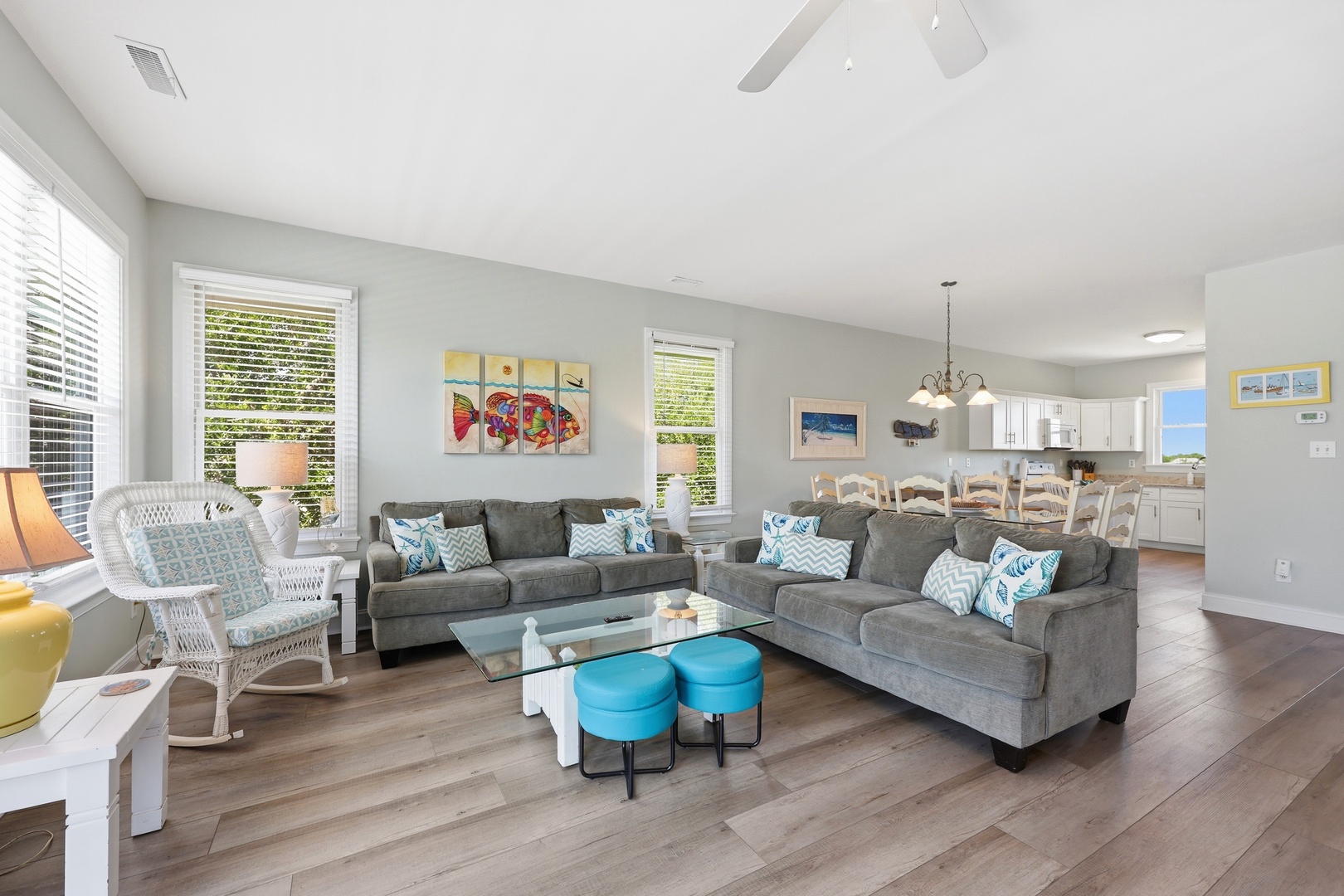 Sink into plush sofas and feel instantly at home in this sunlit living space, where pops of turquoise and coastal art invite you to unwind and connect with your travel companions.