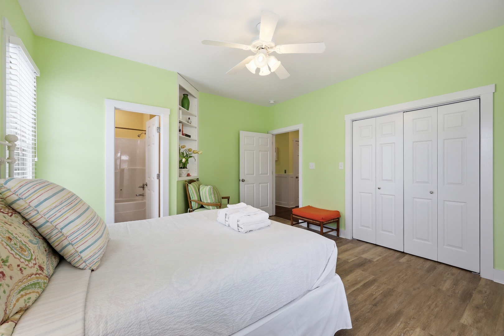 Relax in your cheerful, light-filled bedroom with soft linens, ceiling fan, and ensuite bathroom. Unpack in the spacious closets and unwind in the fresh, calming atmosphere.