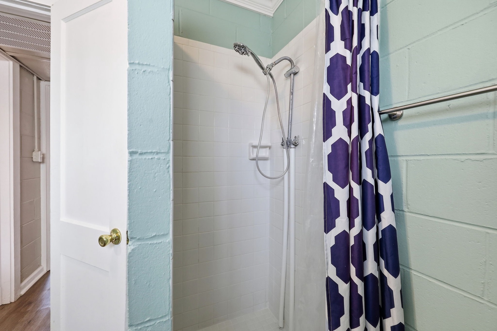 Rinse away the day in your private walk-in shower, styled with a cheerful geometric curtain and soothing coastal hues that make every refresh feel like a mini spa moment.