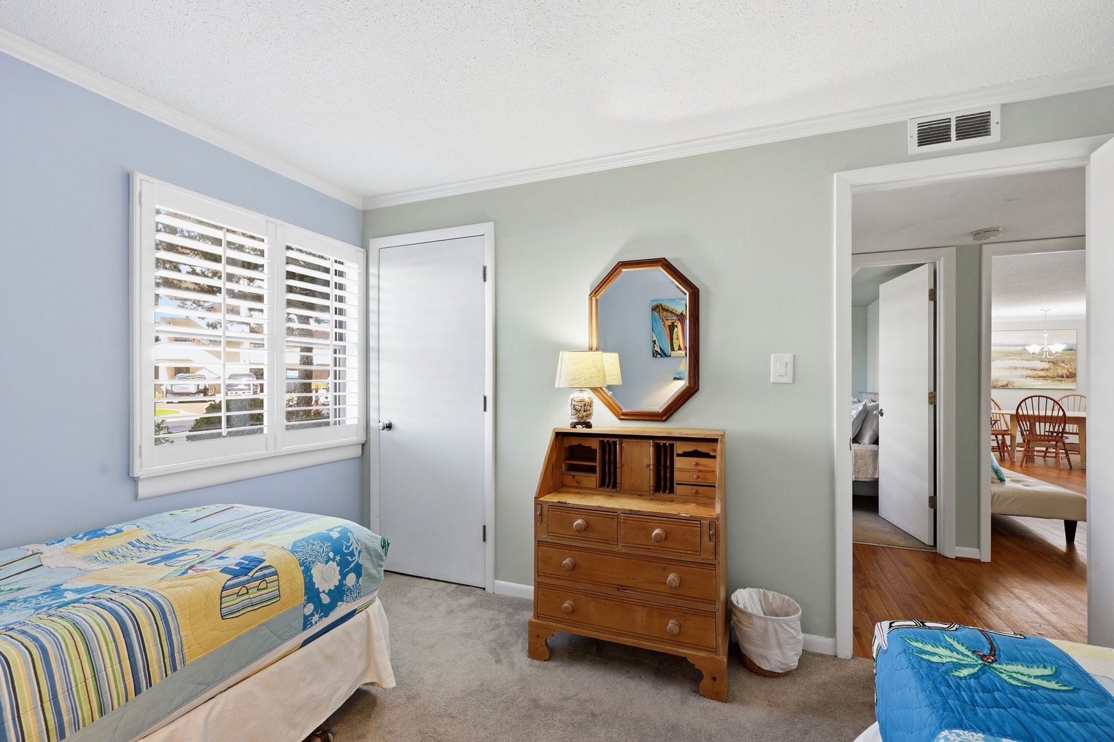 Unwind in your peaceful bedroom retreat with calming coastal tones, comfortable beds, and warm wood accents that create the perfect space for restful nights.