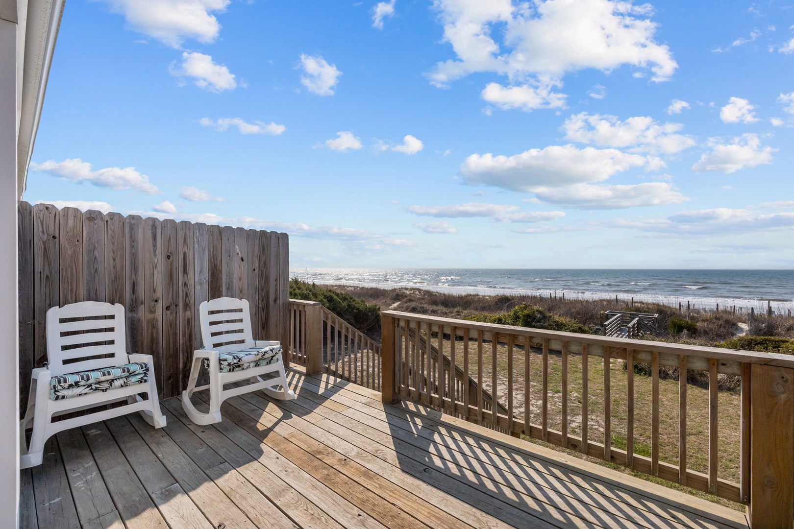 Relax in your private oceanfront deck chairs while taking in stunning sea views and coastal breezes from this perfect seaside retreat.