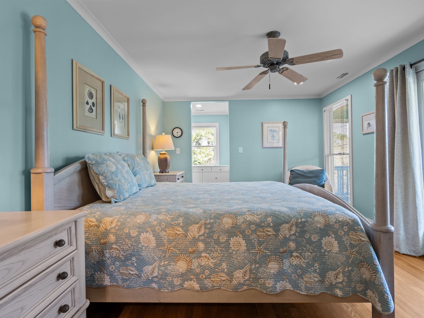 Drift off in your serene coastal bedroom, where soft blue walls and ocean-themed bedding create your perfect seaside retreat.