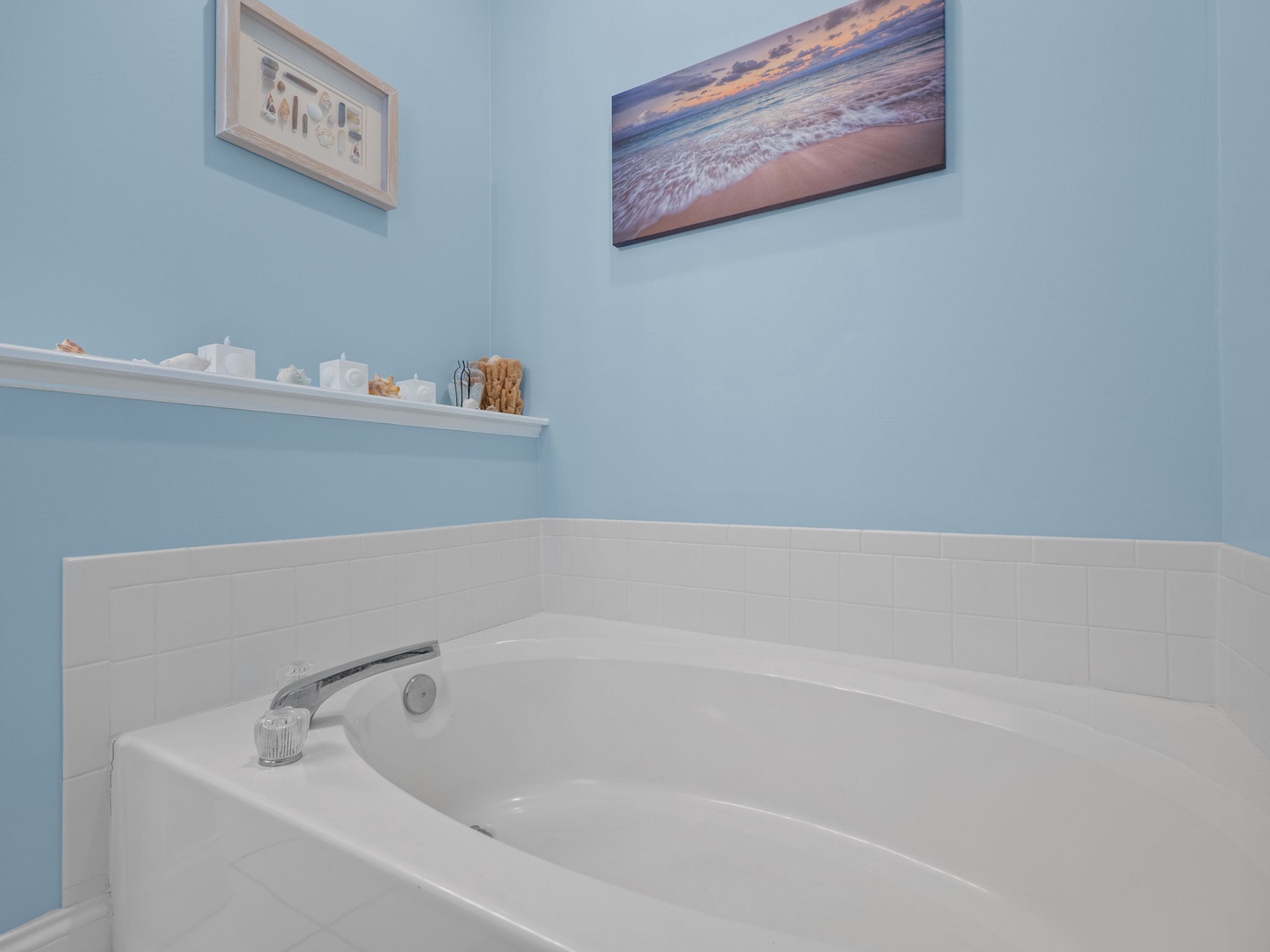 Slip into your private soaking tub surrounded by calming blue walls and coastal artwork for the perfect end to your day.