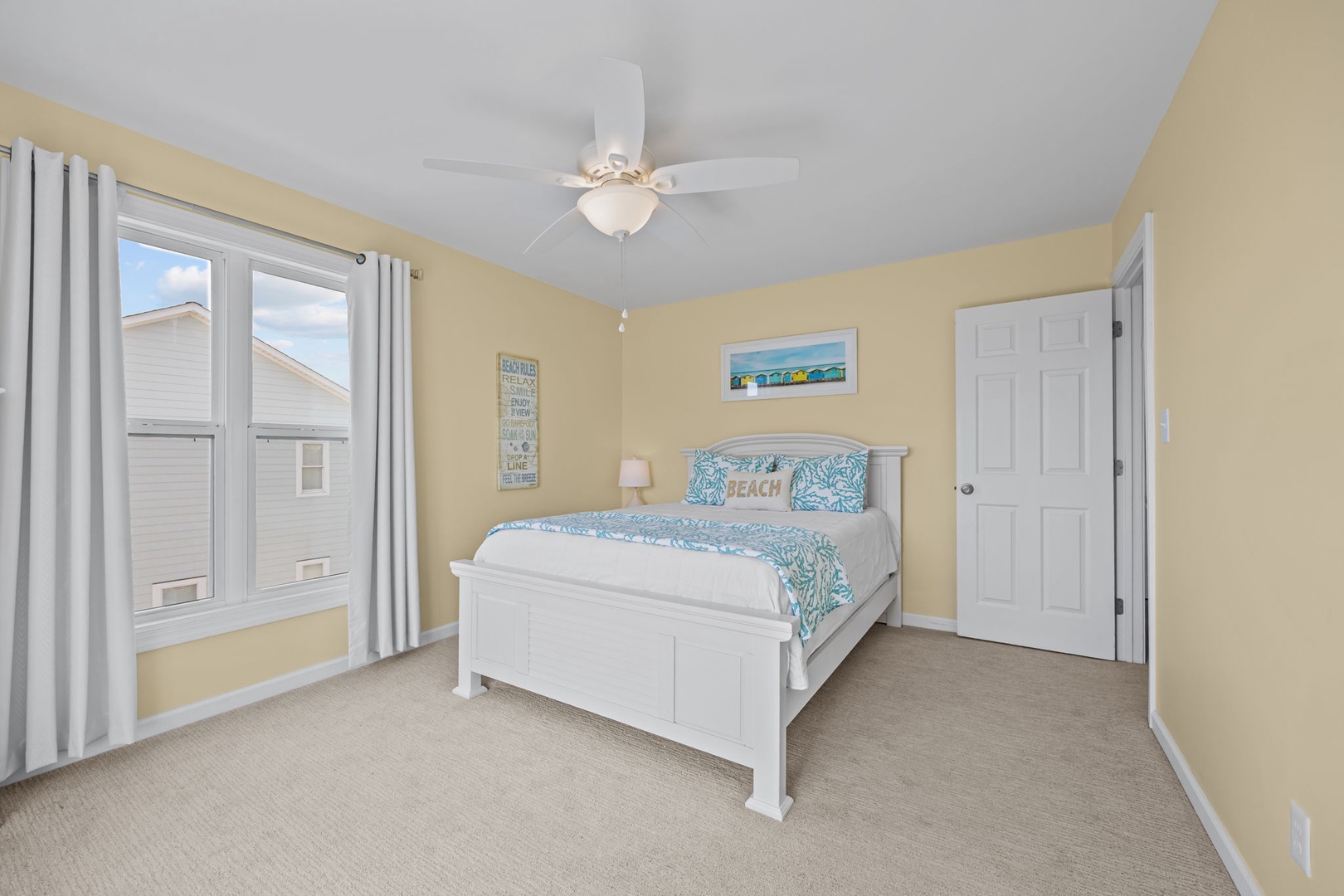 Drift off in this sunny bedroom with coastal decor and a ceiling fan keeping you cool throughout your stay.