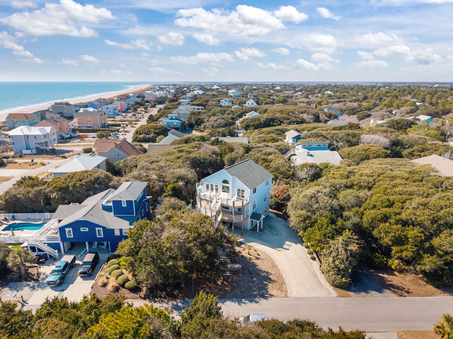 Aerial view showcasing the coastal community setting with beach access and natural surroundings.