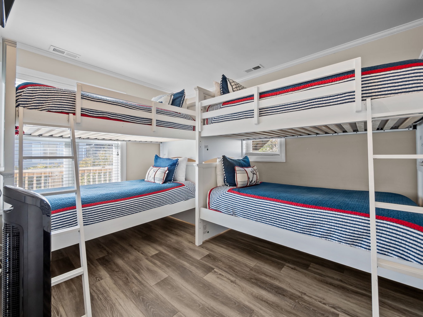 Your family will love this fun bunk room with crisp nautical bedding and city views through the windows.