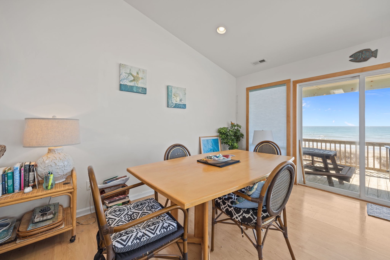 Gather around this welcoming dining table where ocean views frame every meal, creating the perfect backdrop for your coastal retreat conversations.
