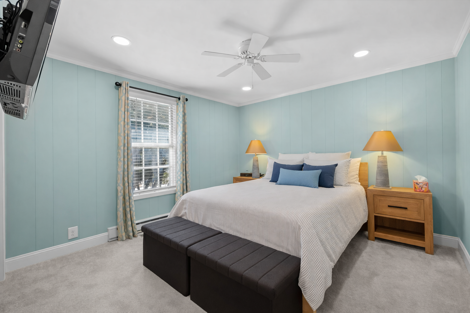 Drift off peacefully in your serene bedroom featuring calming blue walls, a cozy king bed, and gentle lighting for ultimate relaxation.