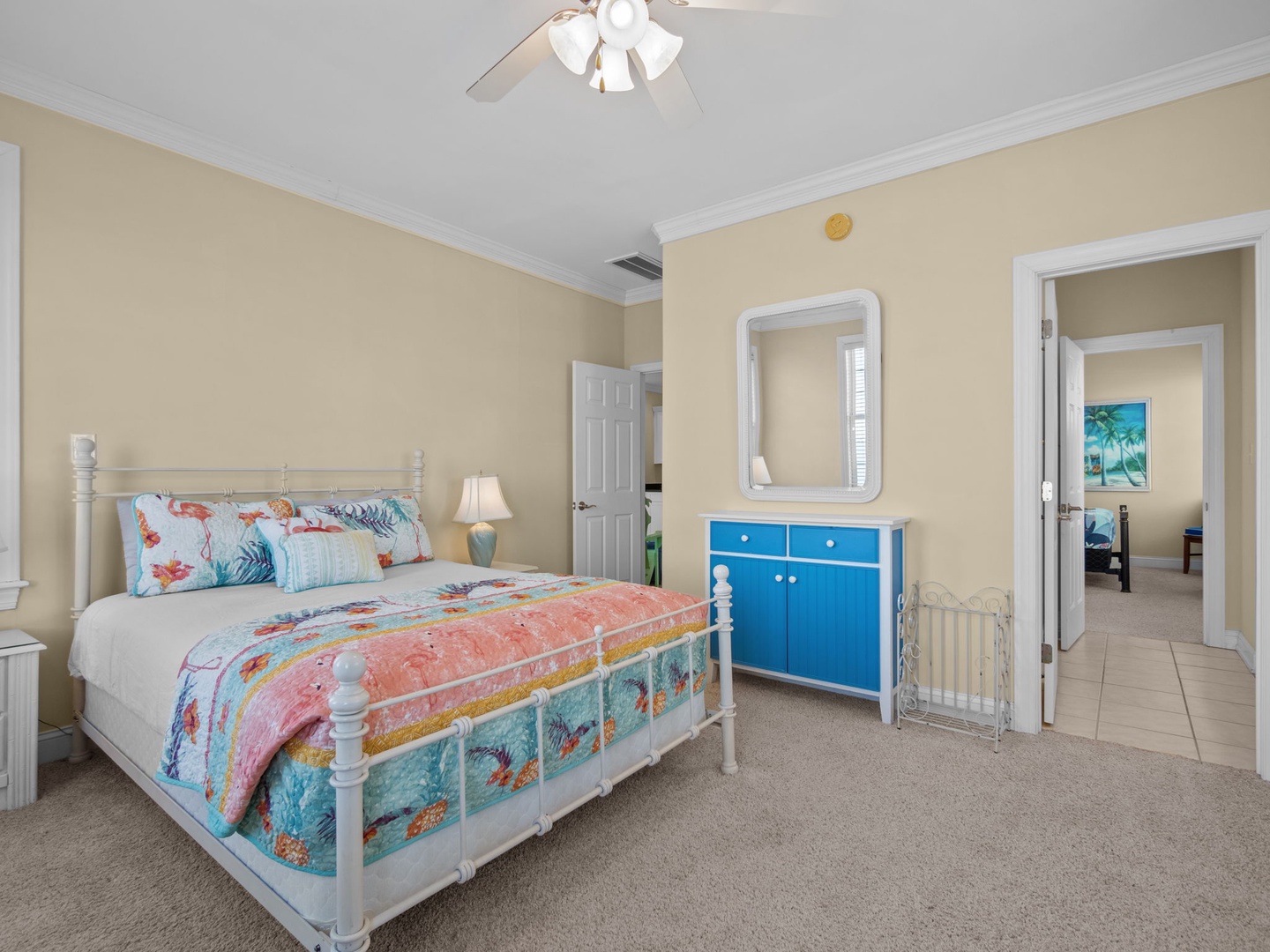 Drift off to dreamland in your cozy bedroom, complete with tropical bedding, gentle ceiling fan, and convenient crib for little ones.