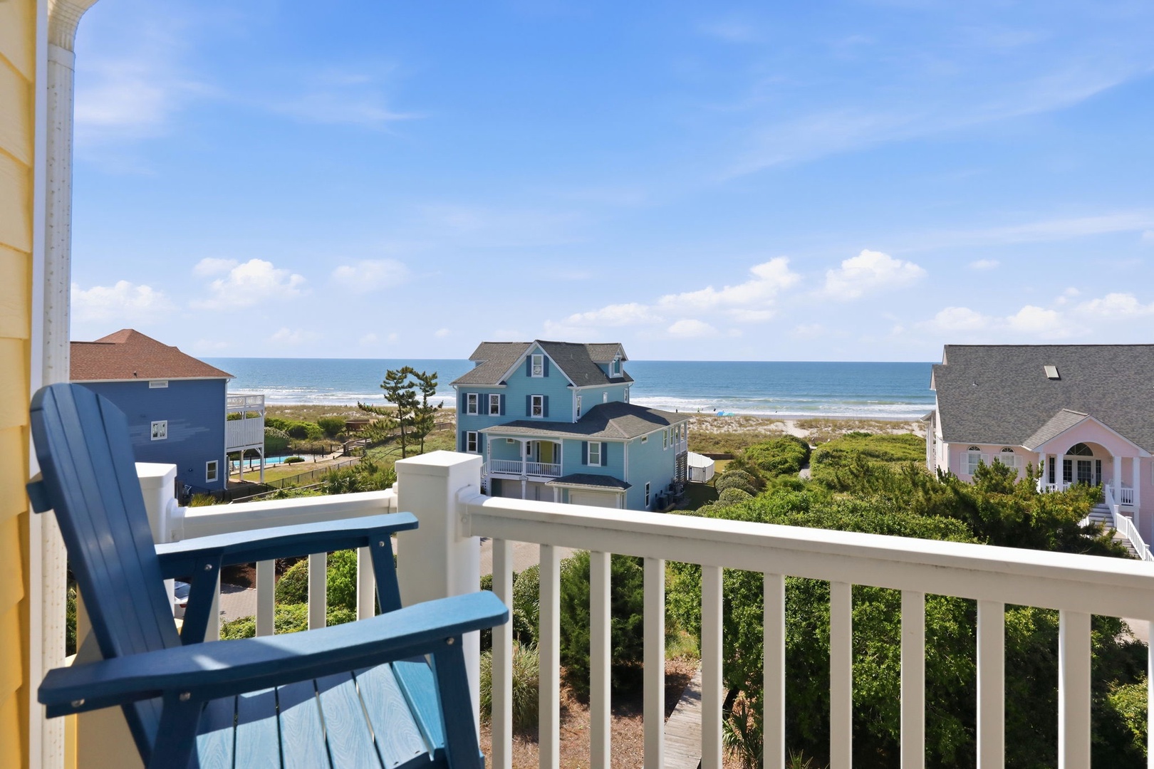 Relax on your private balcony with coastal views stretching to the ocean. Sip morning coffee as sea breezes drift over lush greenery and sandy shores just beyond.