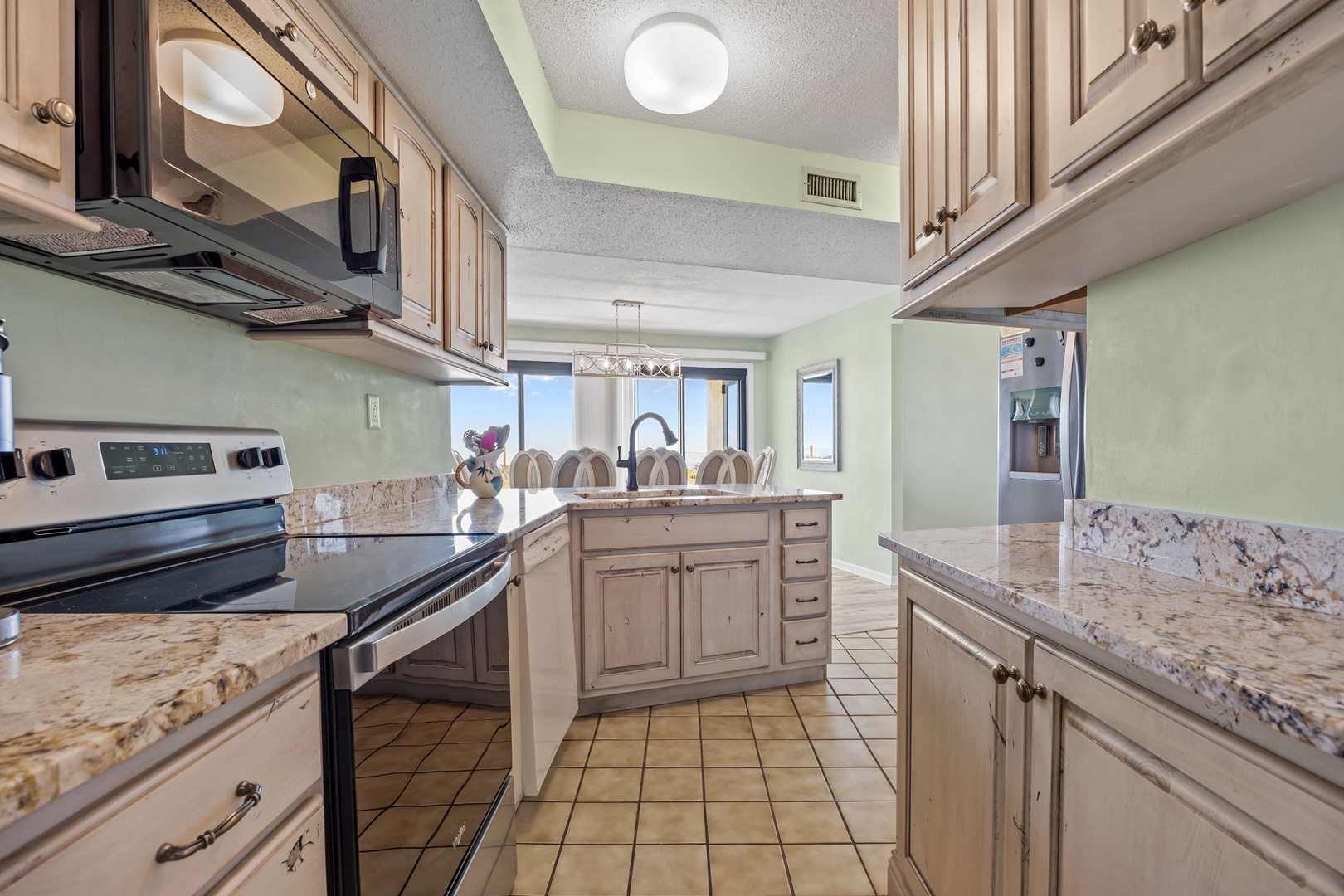 Prepare your favorite meals in this fully equipped kitchen with granite counters, modern appliances, and ocean-view dining.