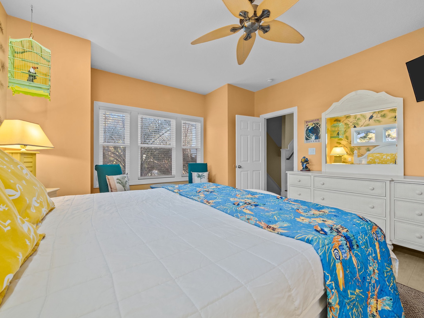 Your cozy bedroom features cheerful ocean-themed decor, a ceiling fan for comfort, and built-in entertainment center for relaxing evenings.