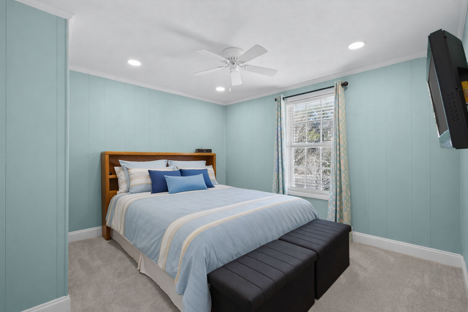 Drift off to sleep in your serene bedroom, where calming blue walls and soft bedding create the perfect sanctuary for rest.