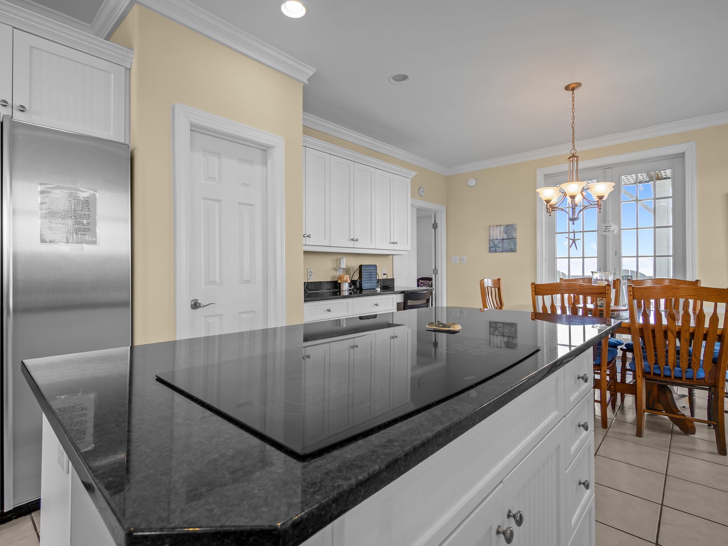 Your fully equipped kitchen features elegant granite countertops, stainless steel appliances, and a bright dining area perfect for preparing home-cooked meals together.