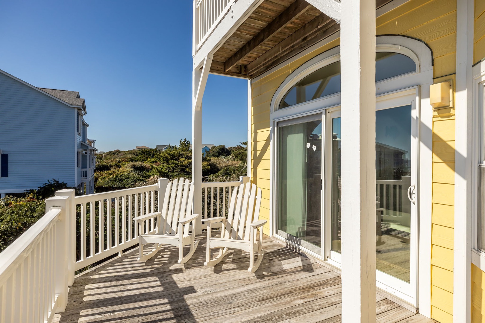 Relax in your private rocking chairs on this sunny deck, where coastal breezes and treetop views create the perfect morning retreat.