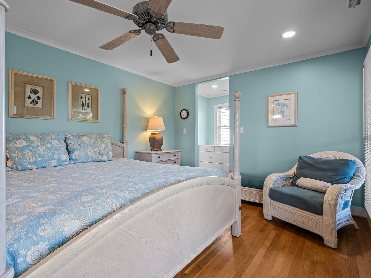 Drift off to sleep in your coastal-inspired bedroom, where soothing blue walls and the gentle whir of the ceiling fan create the perfect sanctuary for rest.