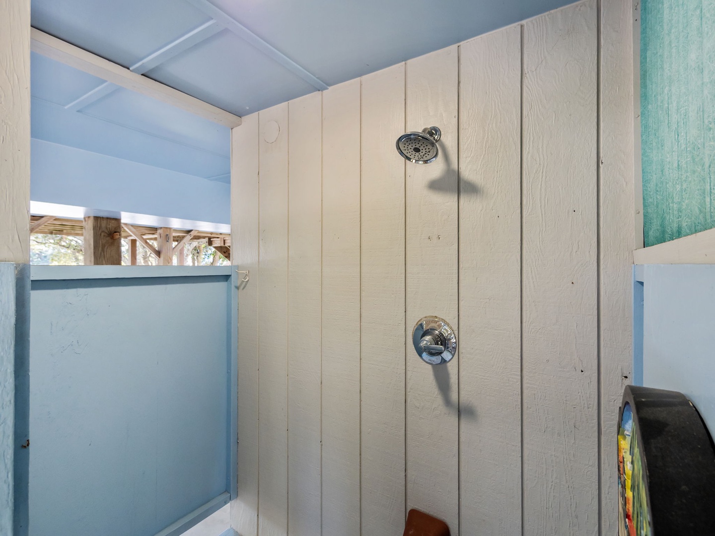 Rinse away your worries in this rustic outdoor shower with fresh ocean breezes and natural wood accents for an authentic coastal experience.