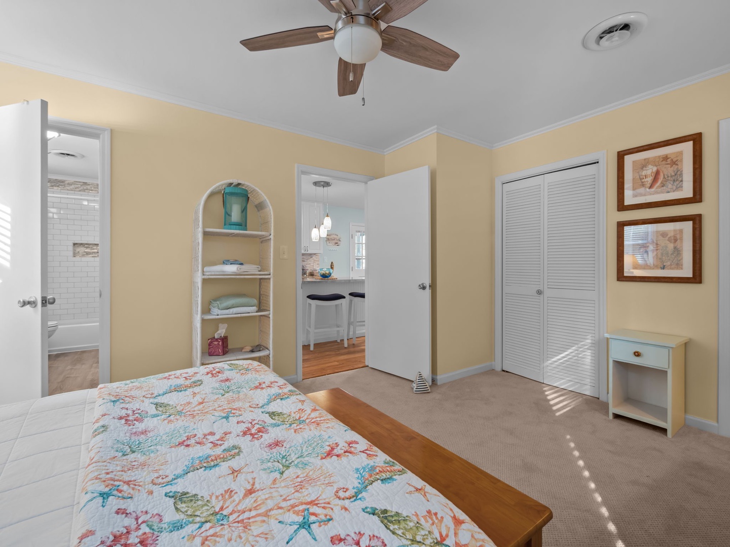 Relax in your comfortable bedroom with tropical bedding, built-in storage, and bright coastal decor that creates a peaceful retreat.