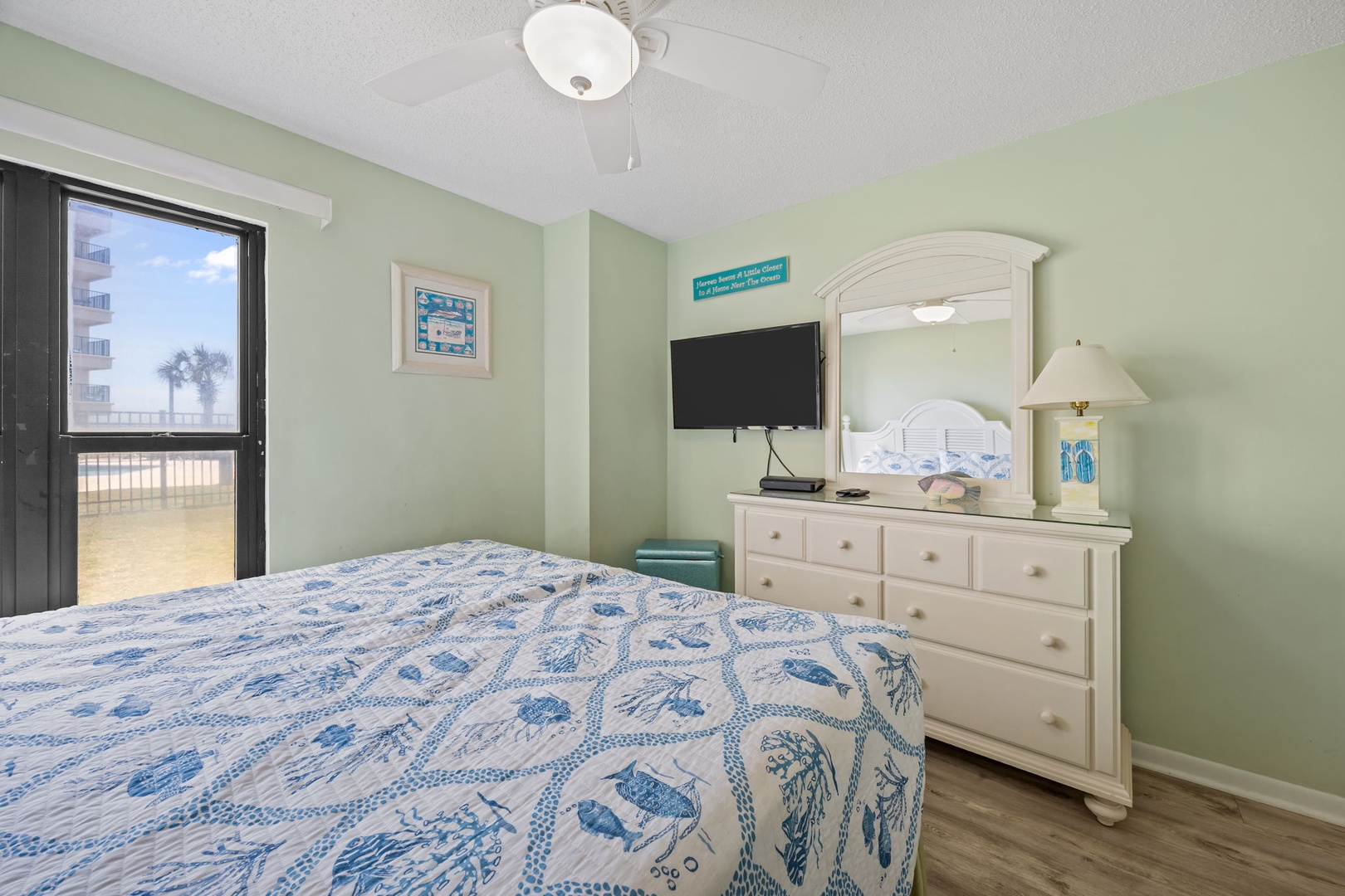 Your peaceful bedroom features soothing coastal colors and an ocean view window that brings natural light and sea breezes into your restful retreat.