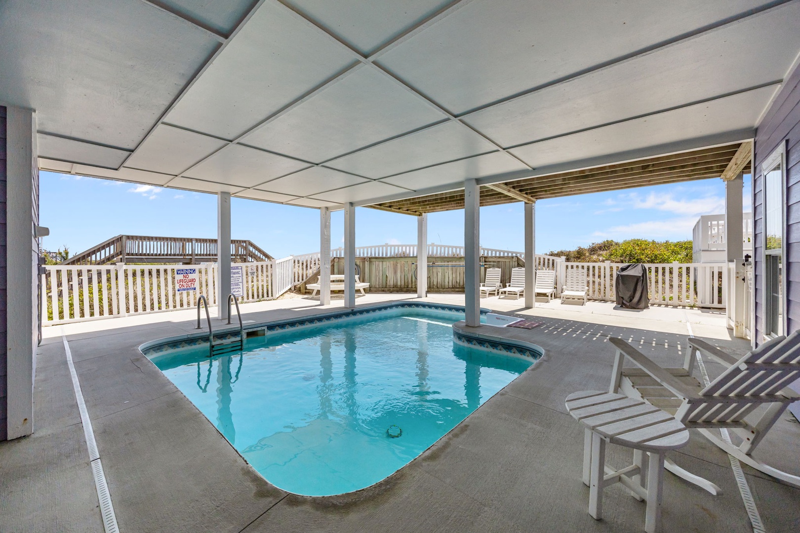 Your private pool oasis awaits with sparkling waters, comfortable lounging chairs, and refreshing ocean breezes from your covered terrace.