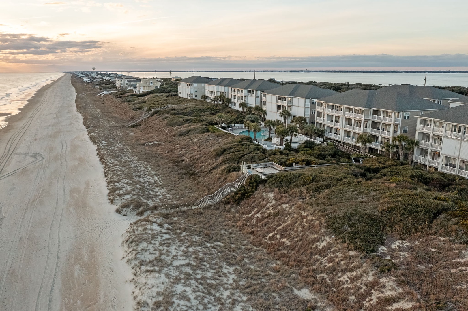 Beachfront resort nestled between pristine sandy shores and protected dunes, offering direct beach access and stunning coastal views.