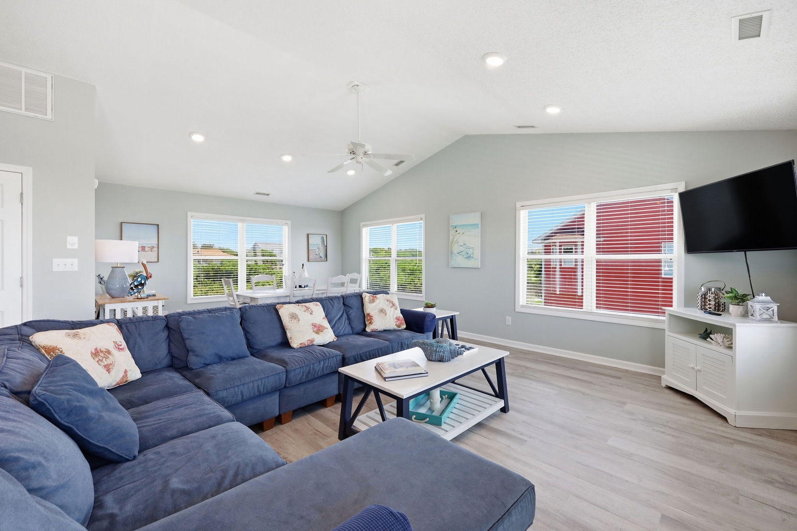 Sink into plush navy seating and enjoy the bright, airy ambiance with vaulted ceilings and soft coastal tones—perfect for your group gatherings.