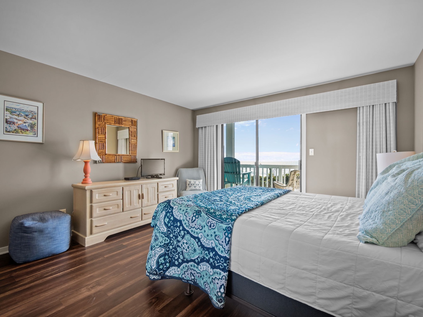 Wake up to stunning ocean views through your private balcony doors, with comfortable bedding and coastal décor creating your perfect beachside retreat.