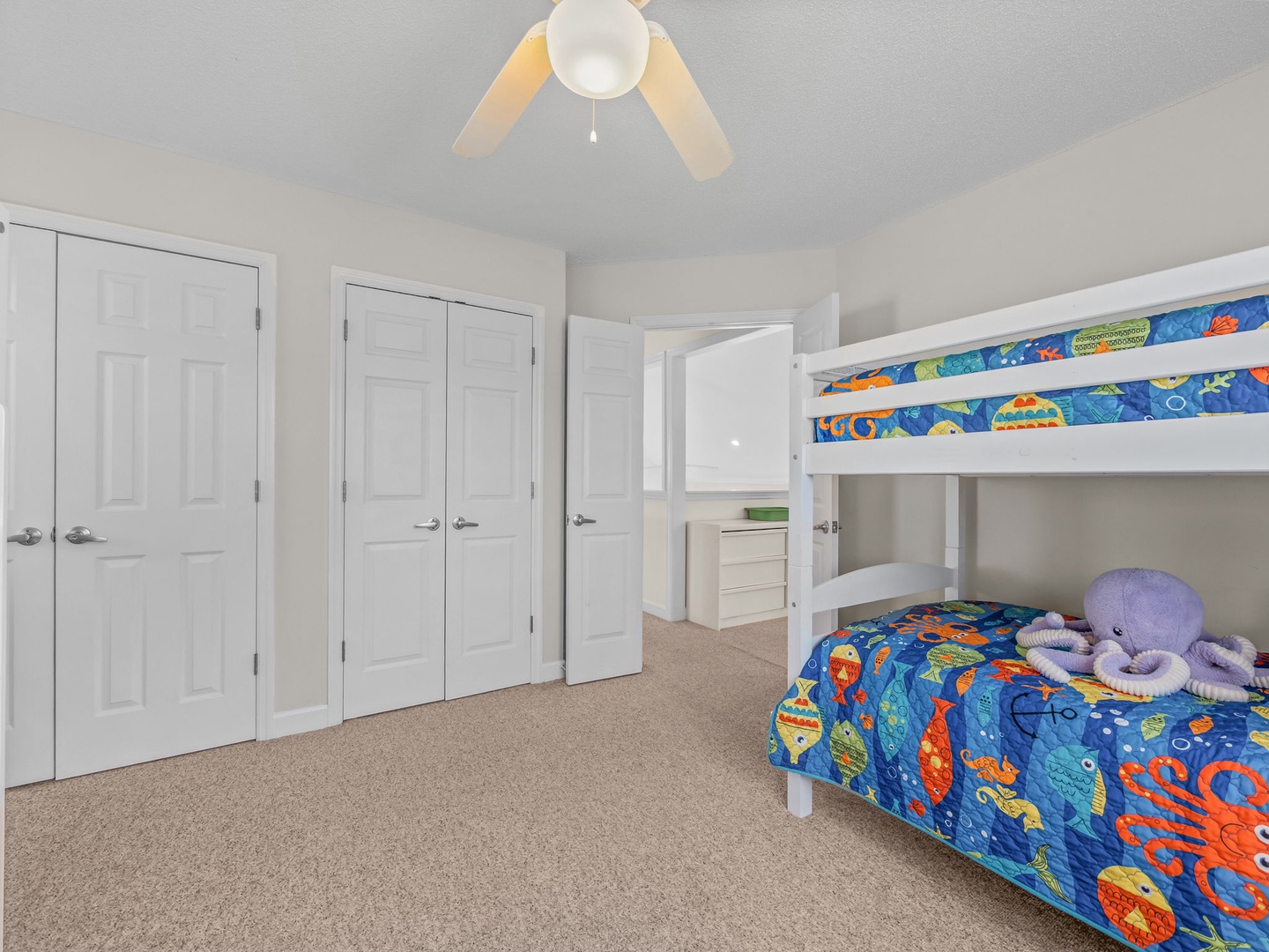 Your kids will love this cheerful bunk room with colorful ocean-themed bedding and plenty of storage space for all their treasures.