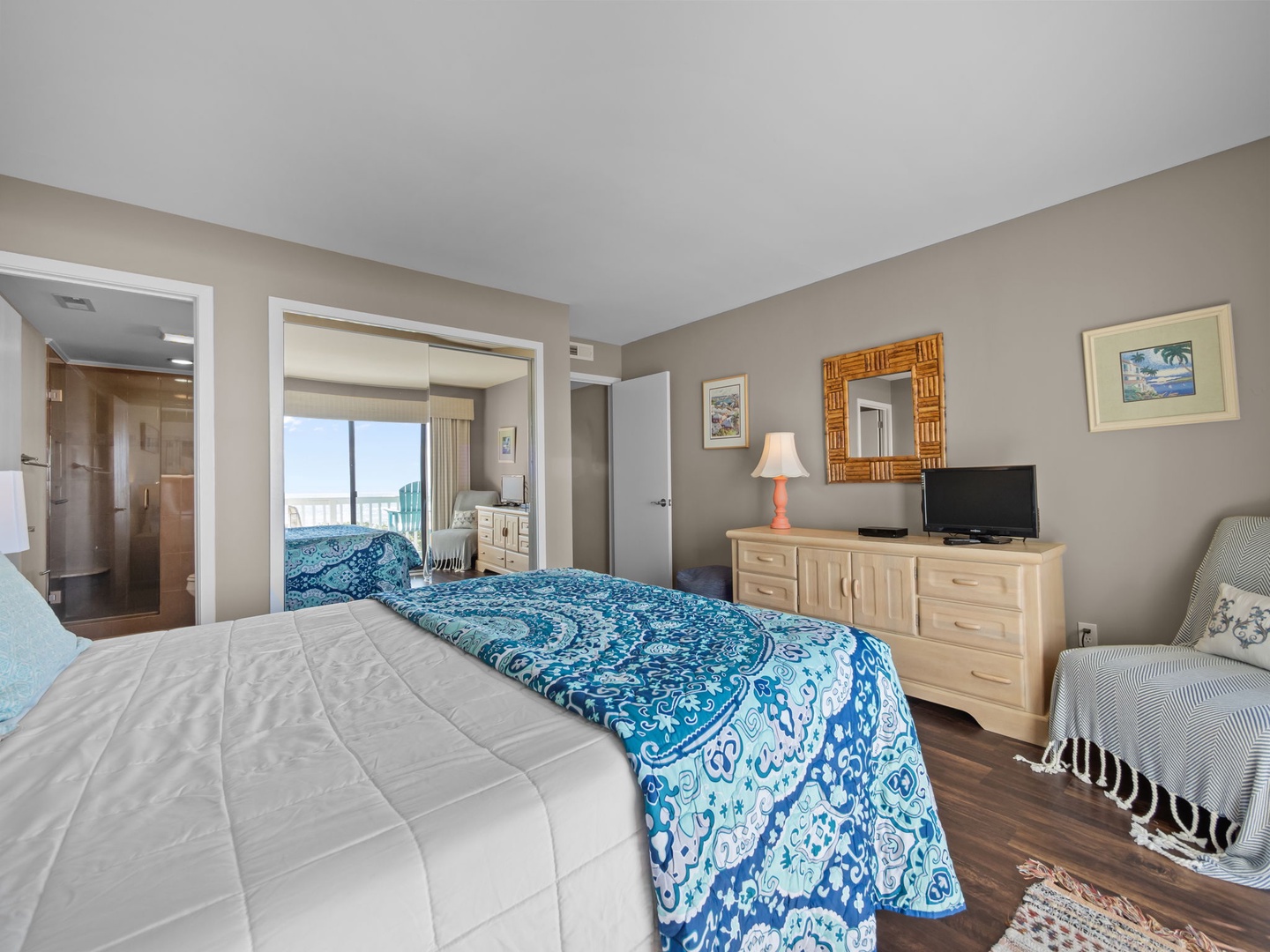 Drift into comfort in your spacious bedroom with plush bedding, modern furnishings, and a cozy reading chair—your perfect retreat.