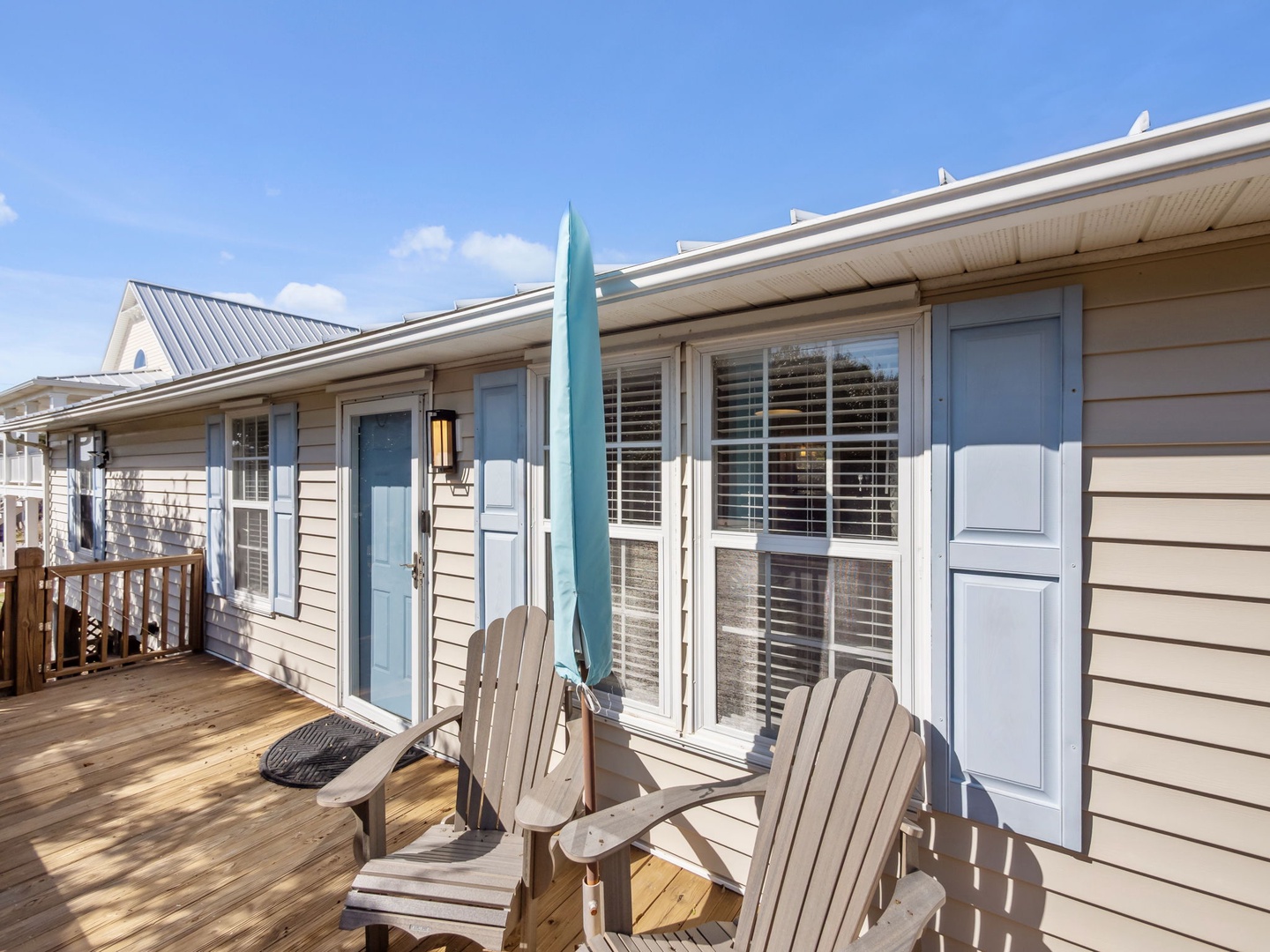 Relax on your private deck with Adirondack chairs and beach umbrella, perfect for morning coffee or evening unwind.