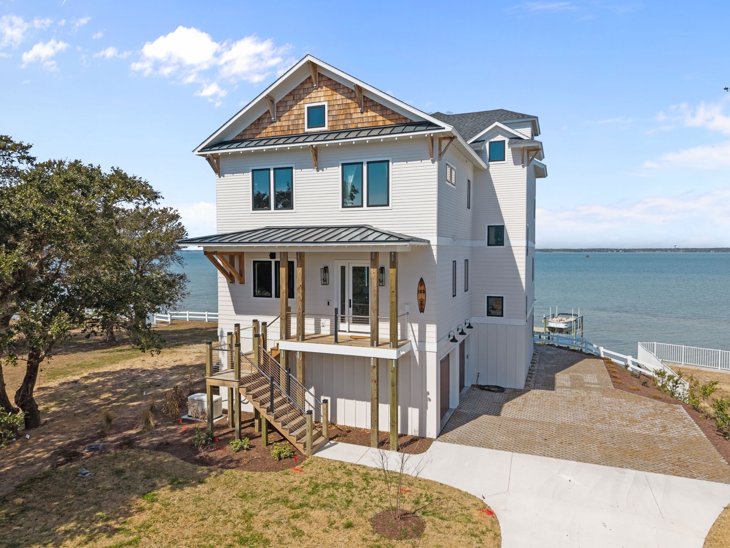Waterfront property featuring elevated design with private dock and expansive water views from this coastal retreat.