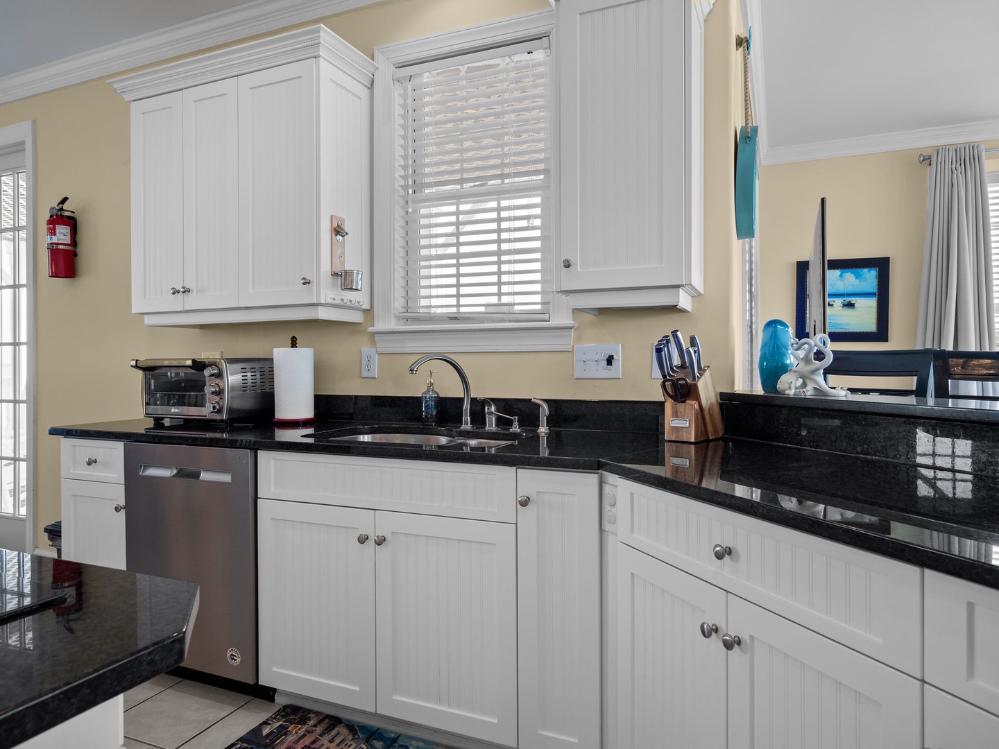 Your fully equipped kitchen features granite countertops, stainless steel appliances, and white cabinetry for effortless meal preparation.