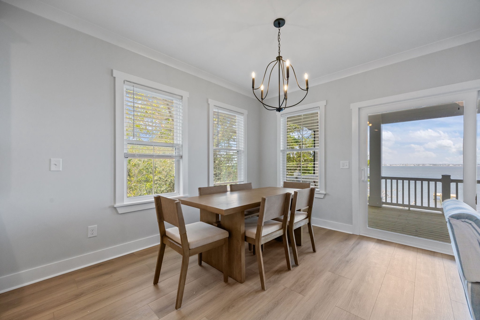 Gather around this elegant dining table for memorable meals while enjoying stunning water views through the open balcony doors.