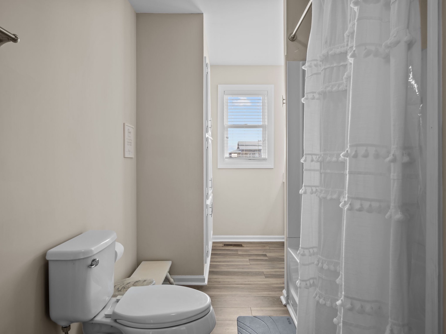 Step into your private bathroom featuring a clean, modern design with fresh linens and natural light streaming through the window.