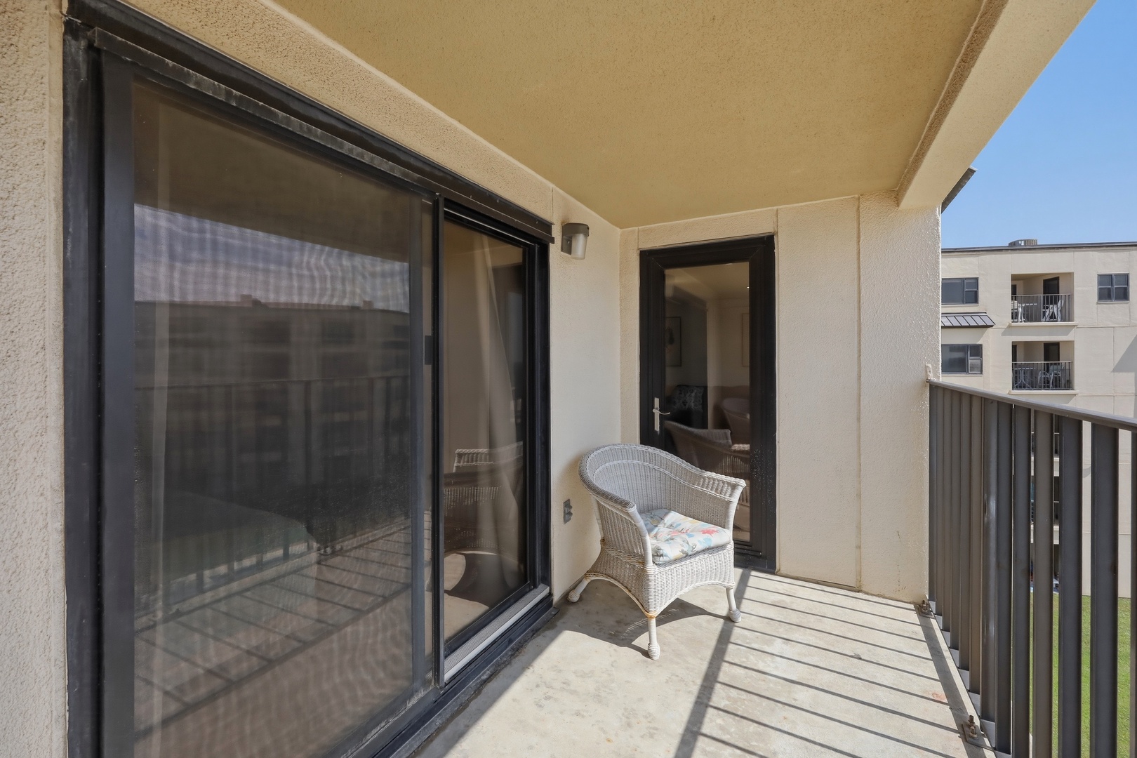 Step onto your private balcony where a cozy wicker chair waits for you to soak in the sunshine and fresh air, perfect for morning coffee or evening relaxation.