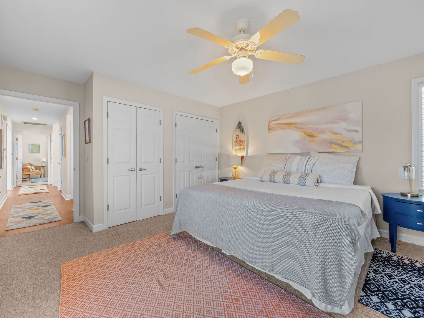 Drift off to sleep in your cozy bedroom featuring a plush queen bed, soft linens, and gentle ceiling fan to keep you comfortable throughout the night.