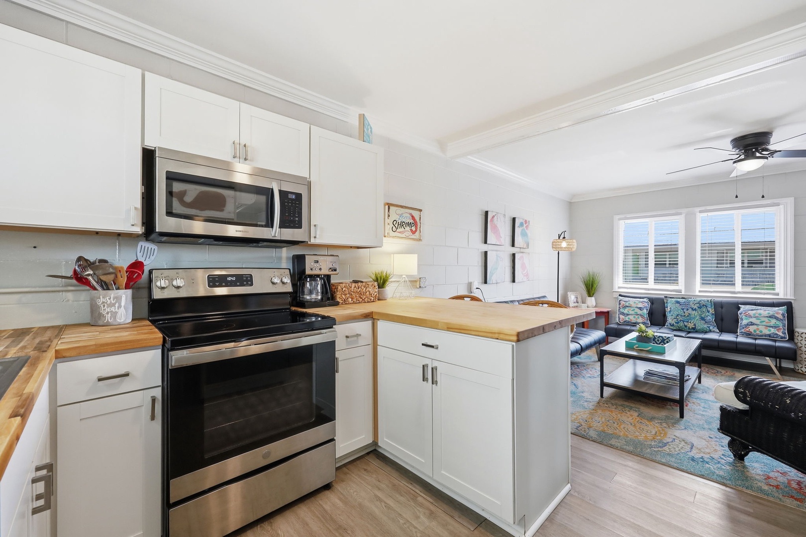 Bright, open-concept space where you can whip up meals in the fully equipped kitchen while chatting with friends relaxing in the adjacent living room.