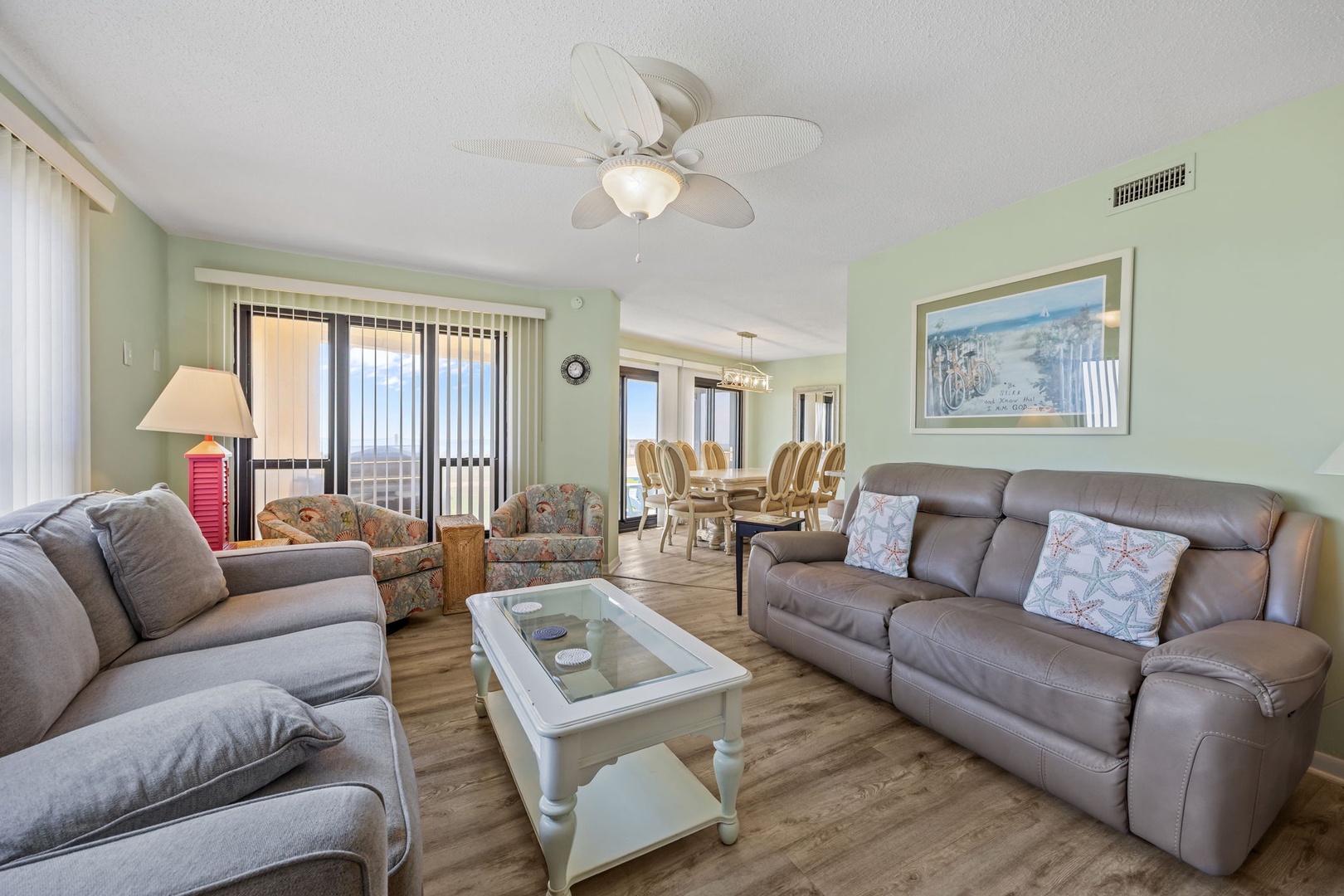 Relax in your spacious living room with comfortable seating and soothing coastal vibes that create the perfect vacation atmosphere.