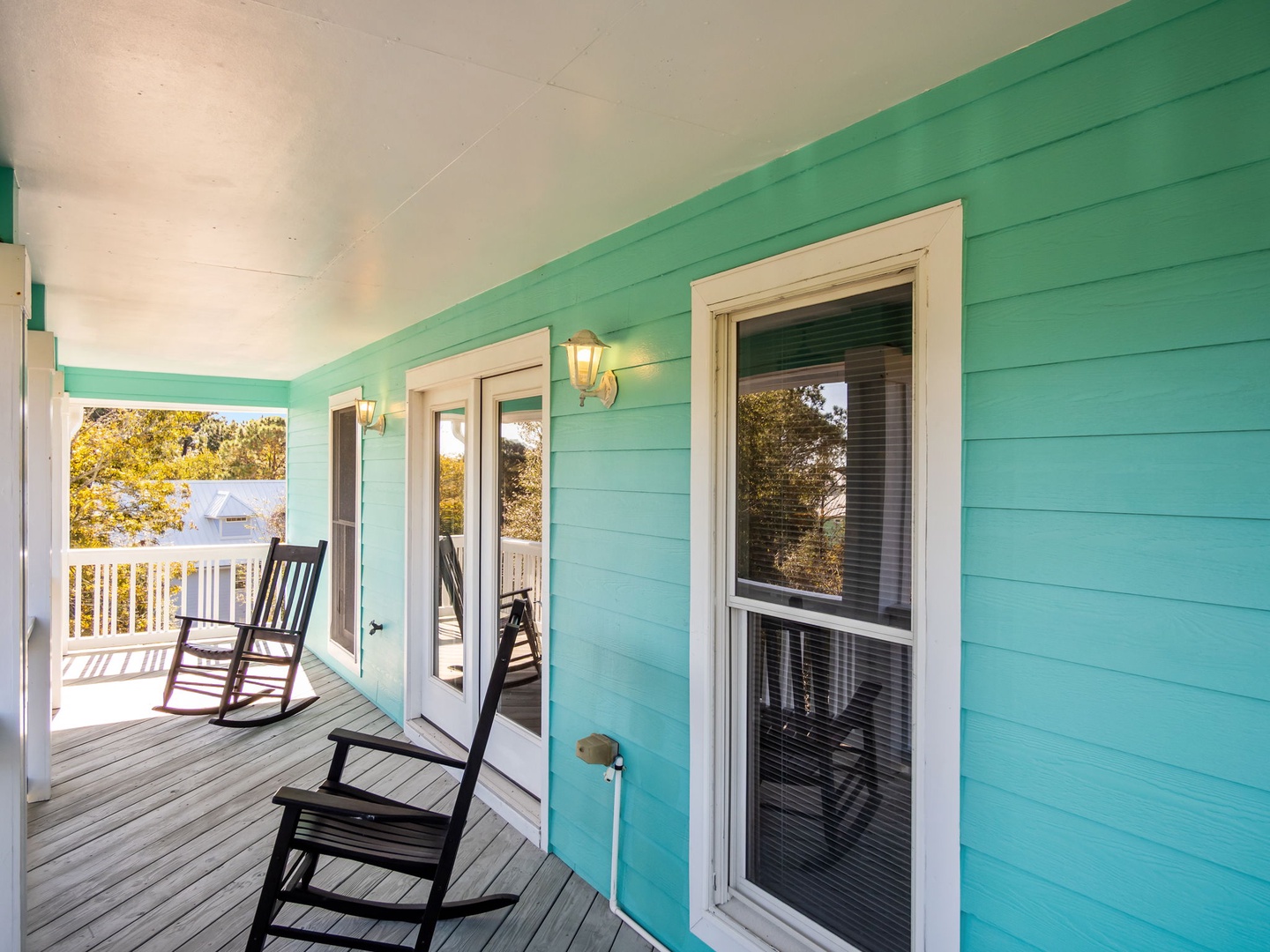Unwind on your private porch with coastal-inspired turquoise walls and gentle rocking chairs that sway in the breeze.
