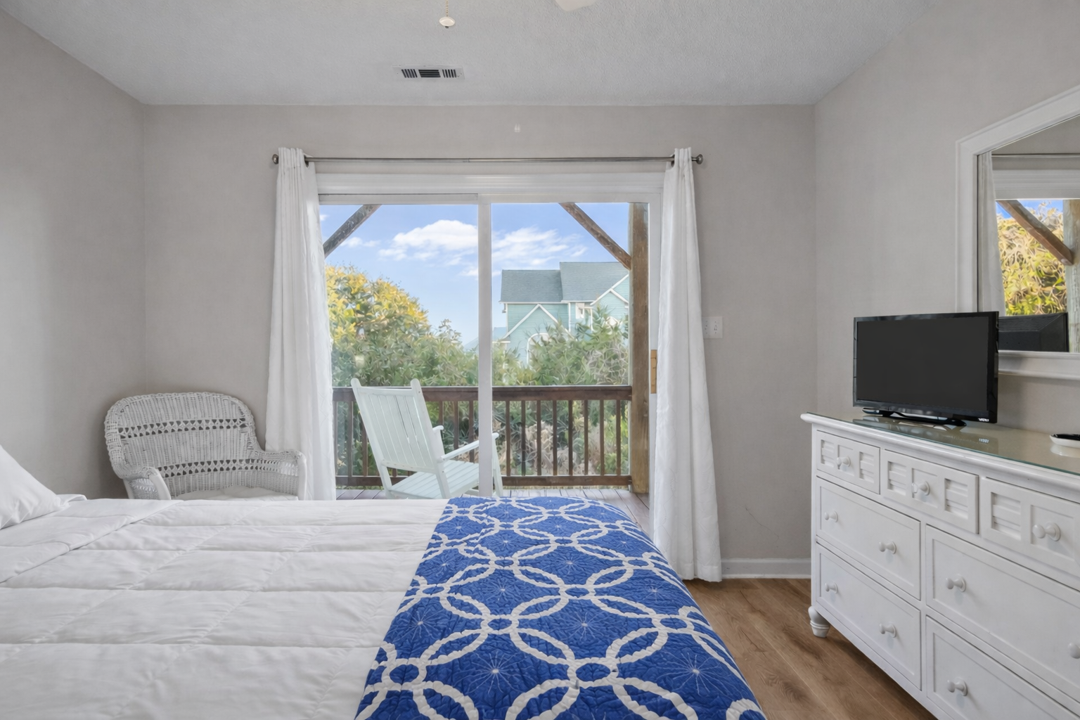 Wake up to treetop views from your comfortable bedroom, where coastal charm meets modern comfort with your private balcony overlooking peaceful surroundings.
