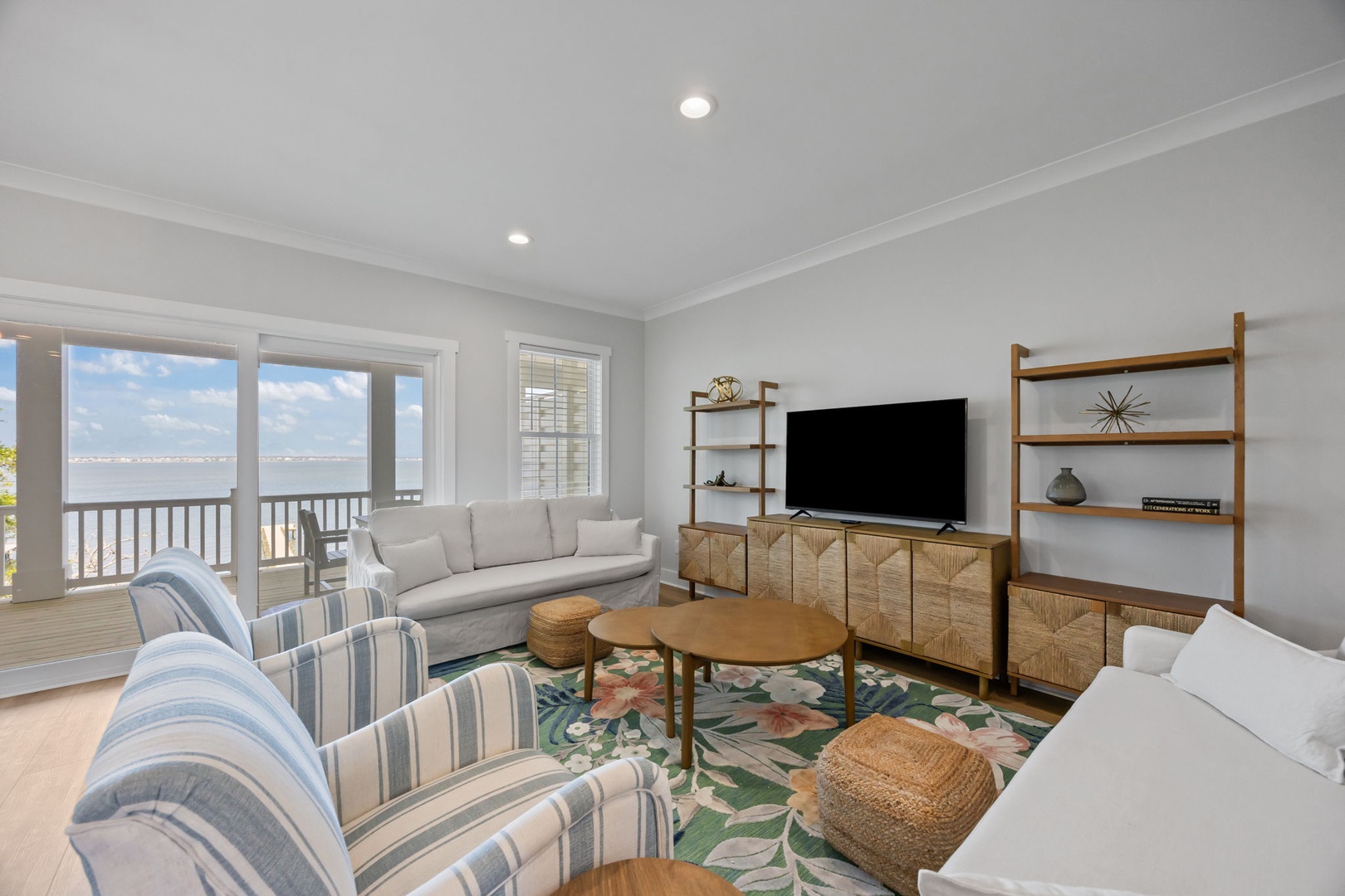 Relax in your bright living room where coastal views meet comfort—perfect for unwinding after beach adventures.