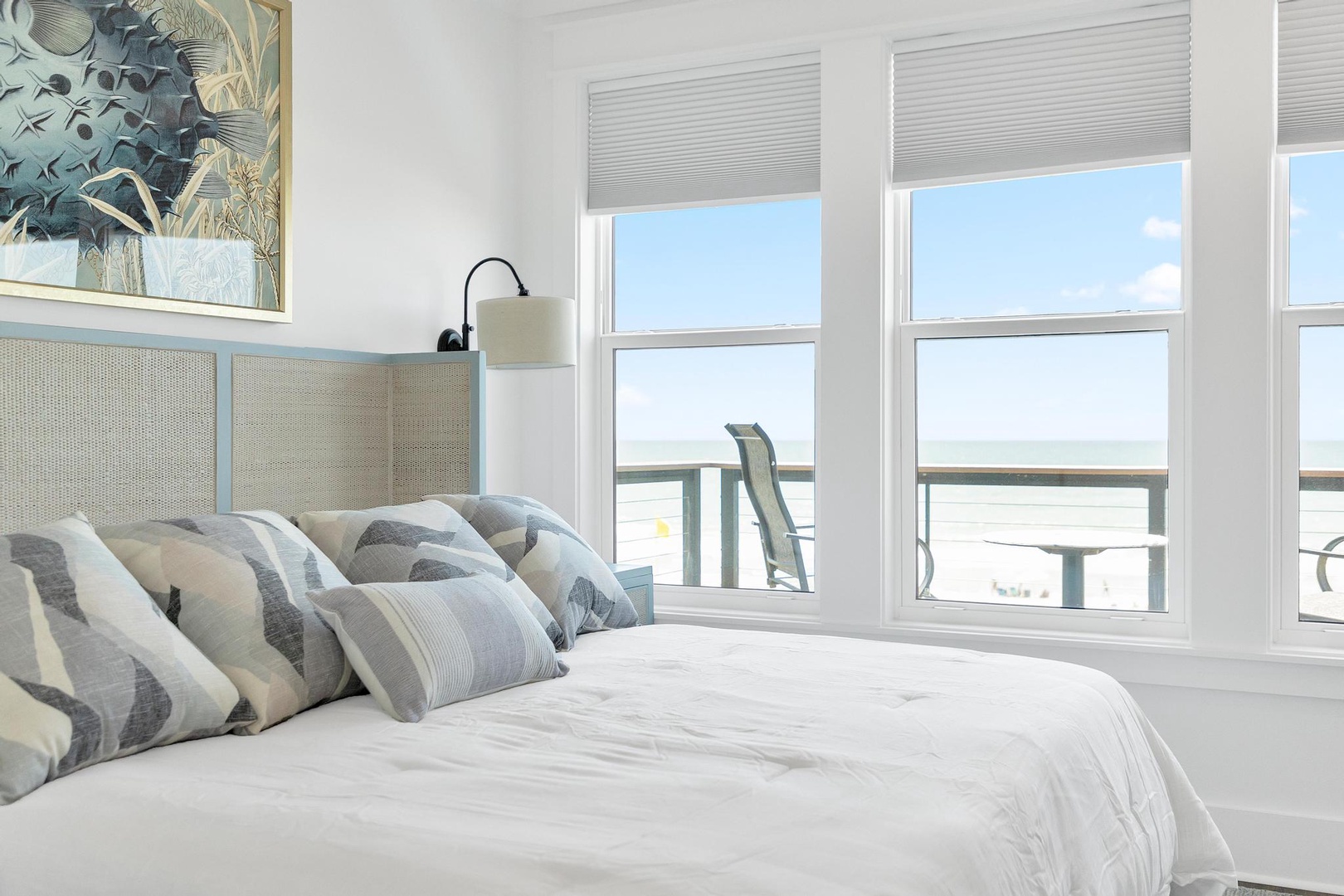 Wake up to ocean views from your bright, coastal-style bedroom. Soft linens and serene decor create the perfect beach escape.