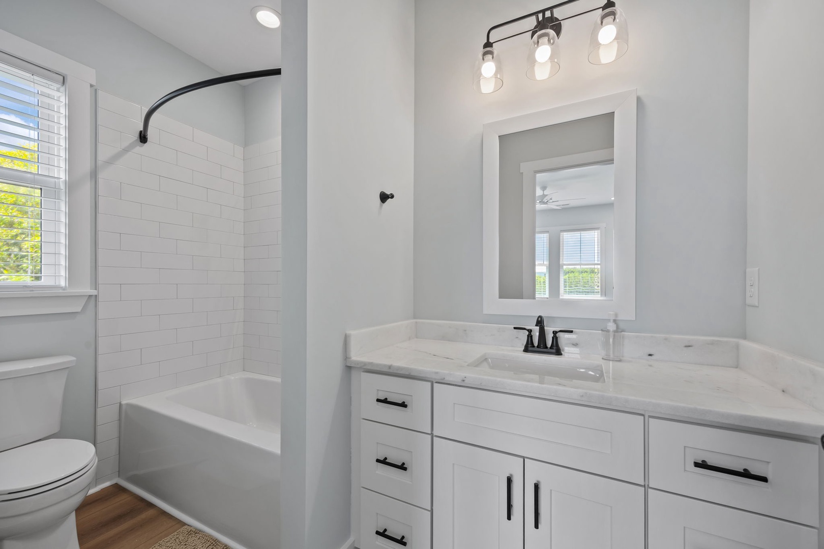 Refresh in your private spa-like bathroom featuring a marble vanity, modern fixtures, and stylish subway tile shower—your perfect morning retreat.