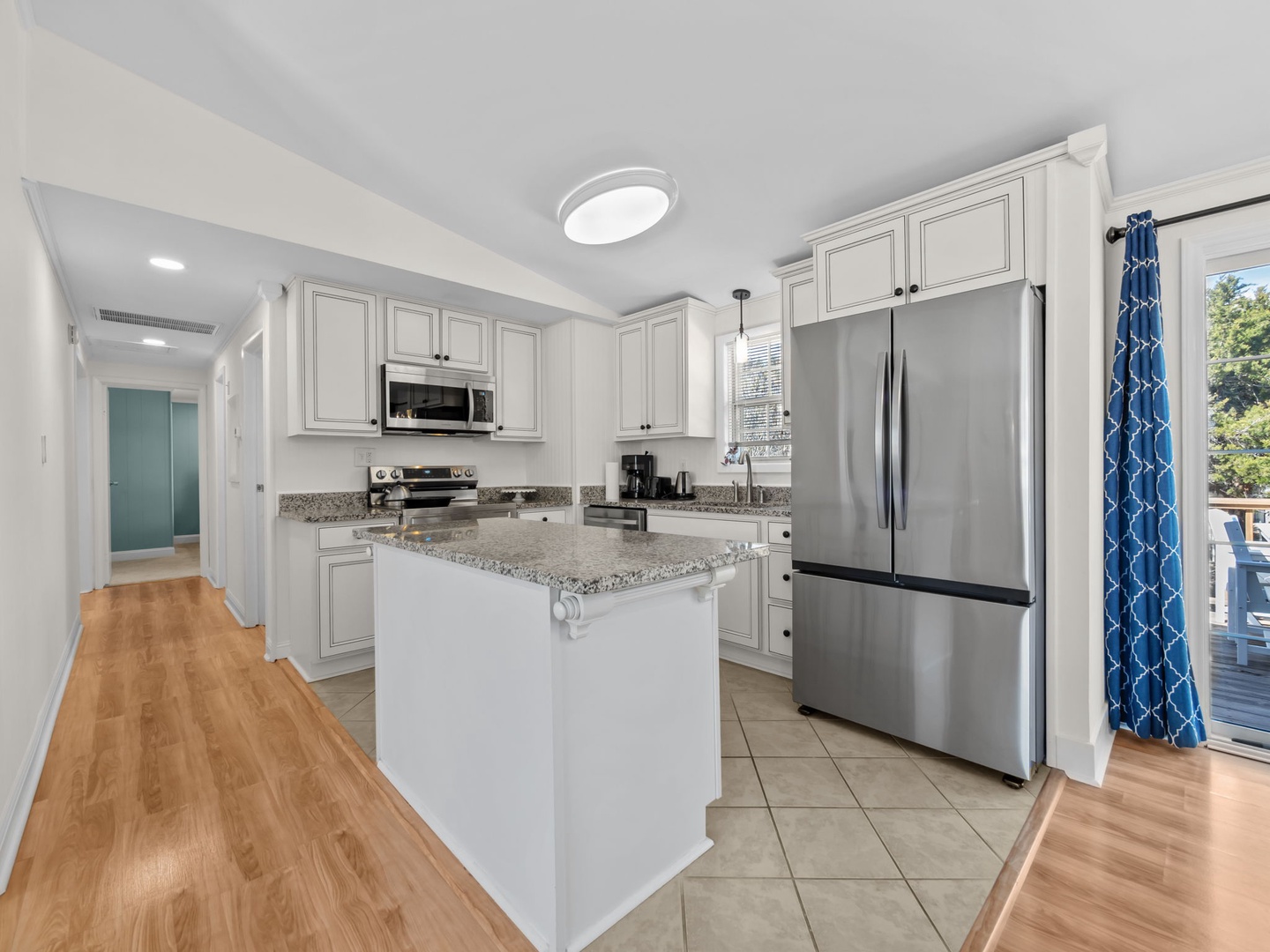 Your fully-equipped kitchen awaits with granite countertops, stainless appliances, and island perfect for morning coffee or meal prep.
