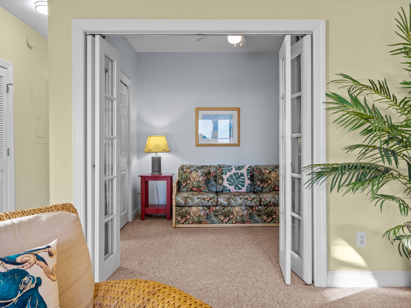 Step into your peaceful retreat where tropical touches and cozy seating create the perfect spot to unwind after exploring.