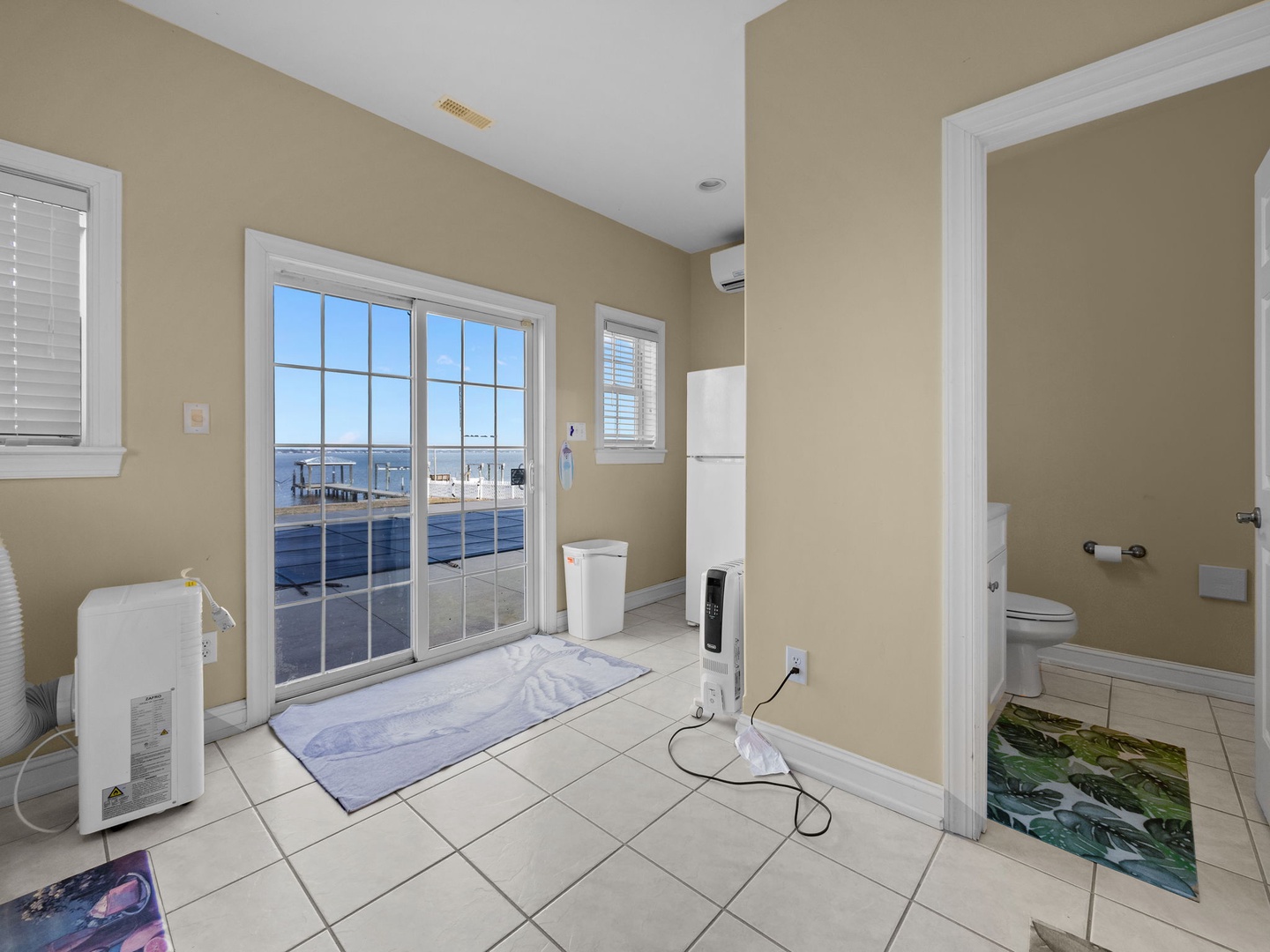 Refresh in your spacious bathroom featuring stunning water views through floor-to-ceiling windows and modern amenities for comfort.