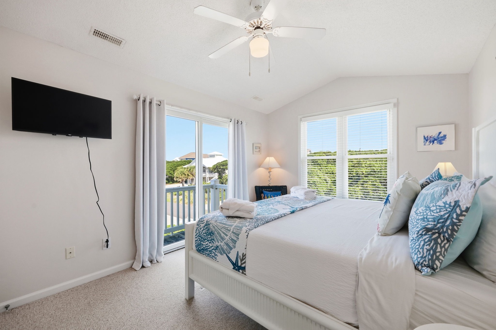 Drift off in this serene bedroom with calming coastal touches and natural light streaming through your private balcony doors.
