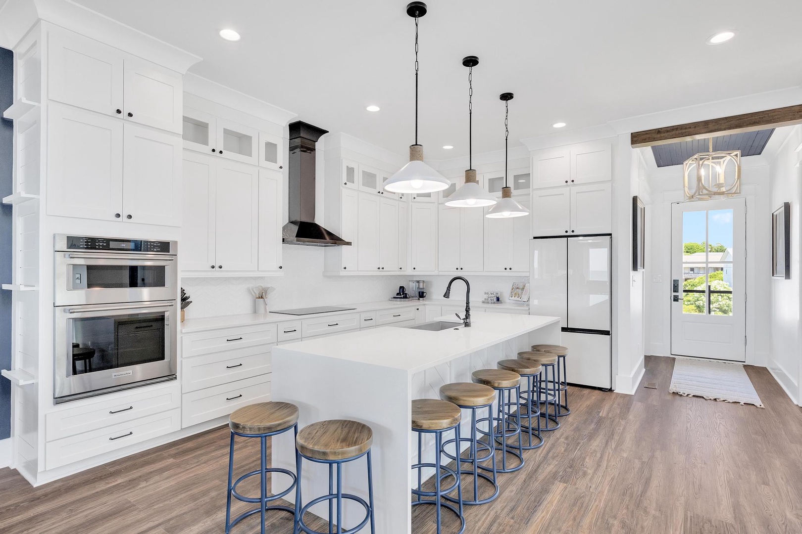 Step into your gourmet kitchen where crisp white cabinetry meets sleek countertops. Gather around the spacious island with friends and family, perfect for meal prep and morning coffee.